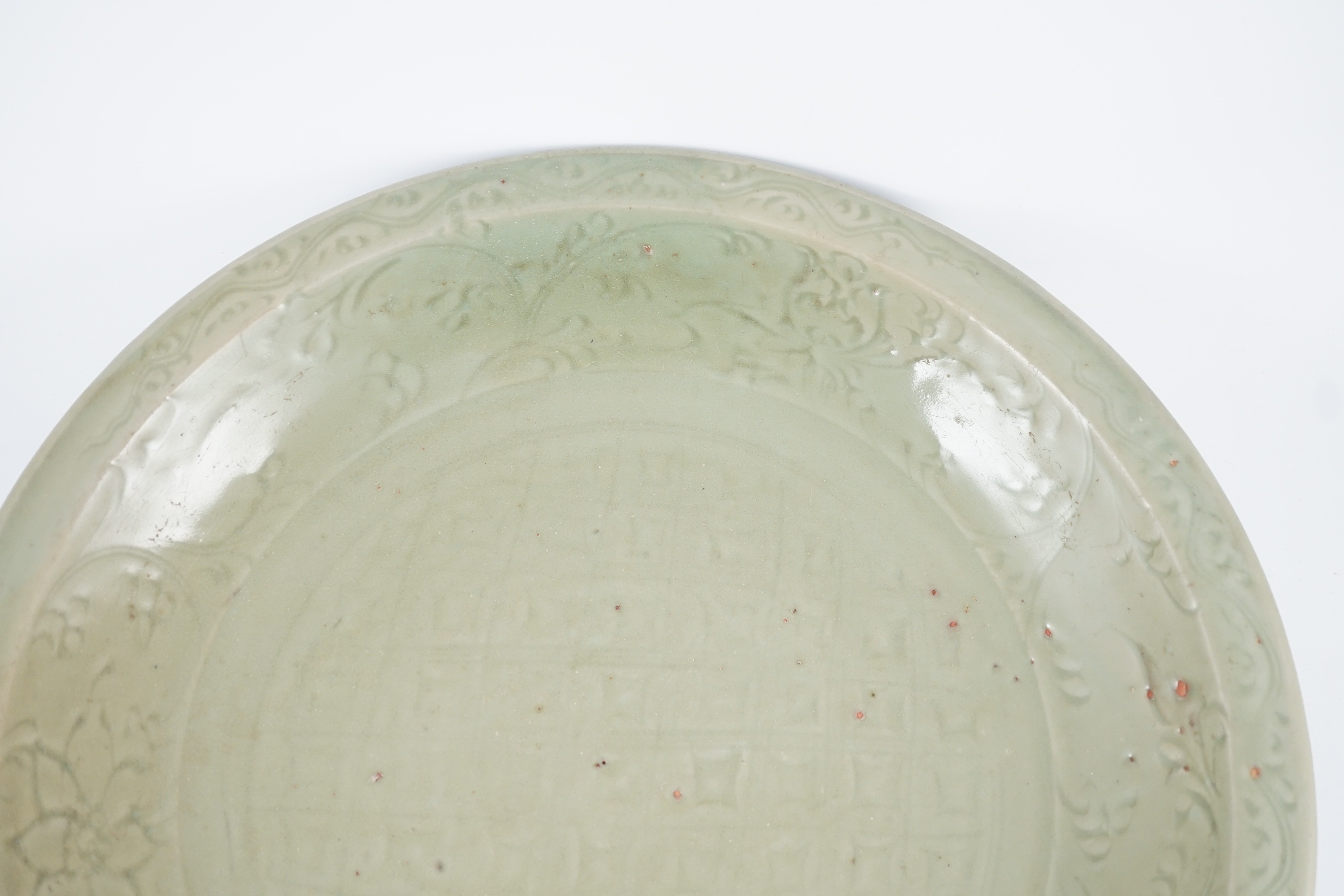 A Chinese Ming Longquan celadon ‘diaper and floral’ charger, 15th century, 45cm diameter, wear to glaze